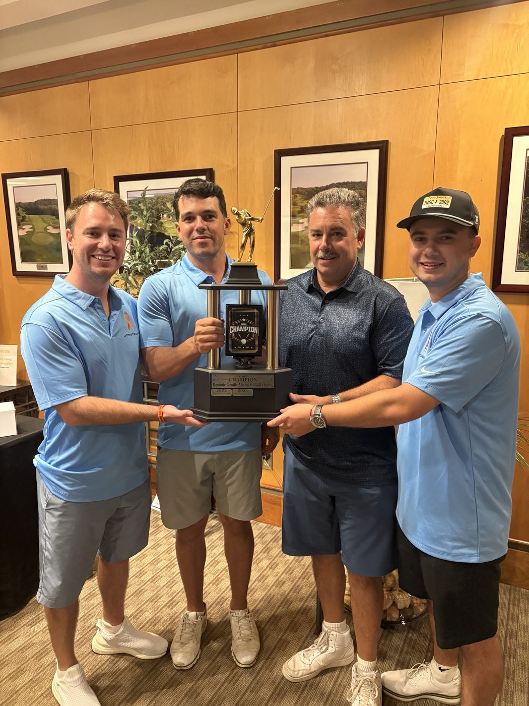 The winning foursome from the 2025 Dominic Gentile Memorial Golf Outing holding the champion's trophy.